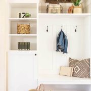 Mudroom with family name sign art, seating bench and lockers.