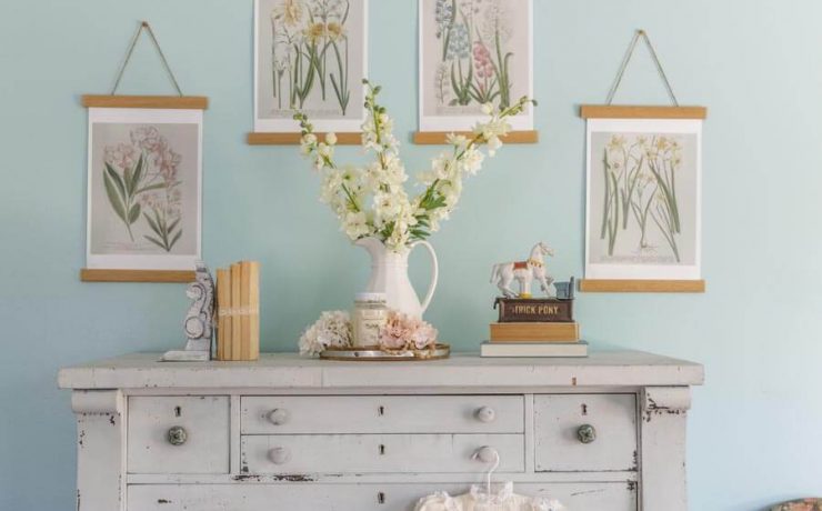 Shabby chic bedroom dresser with DIY botanical prints, vintage children’s clothing and fresh spring bouquet