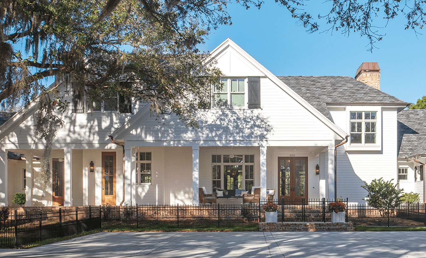 Custom white farmhouse with wood paneling cape cod style