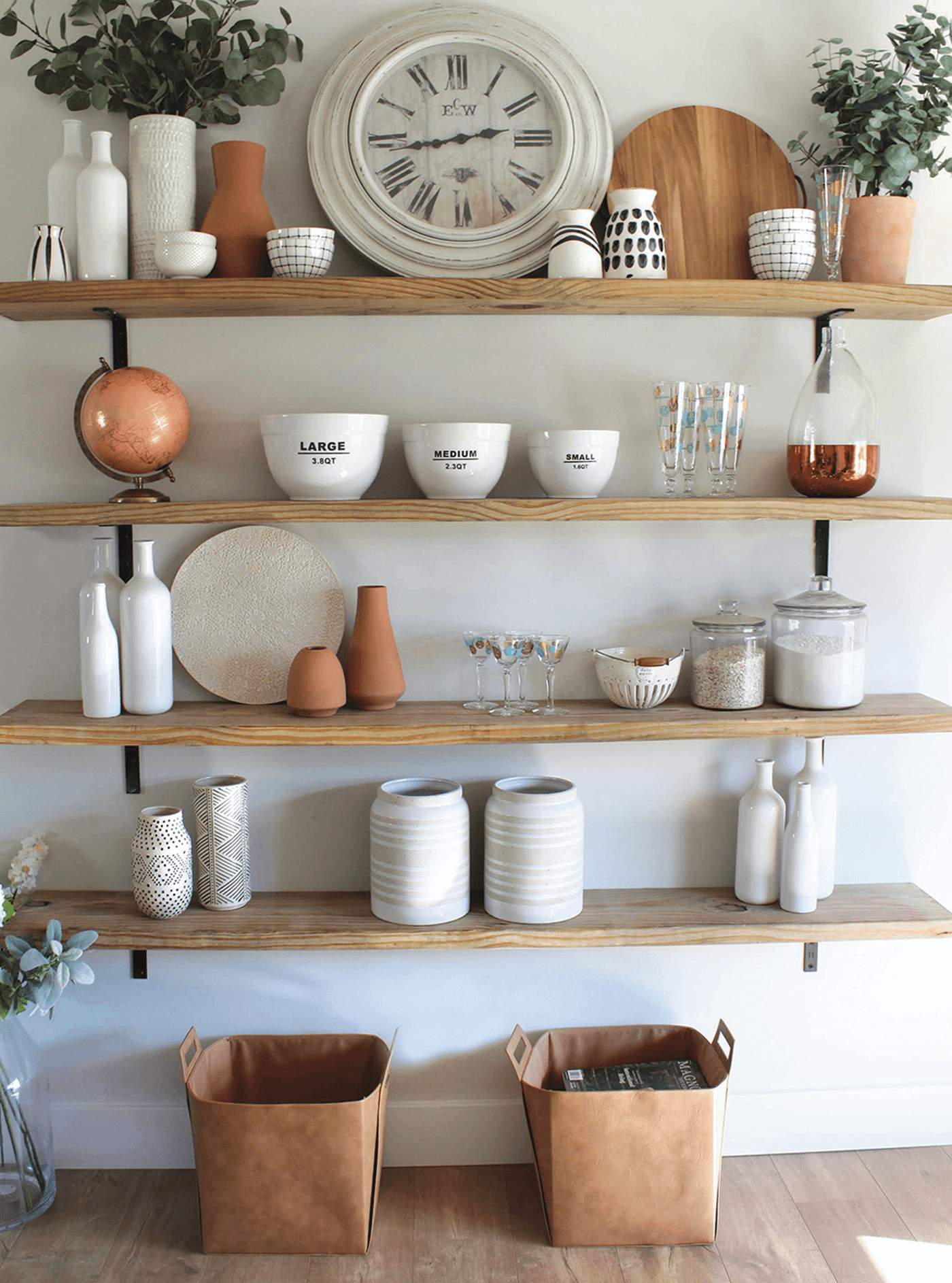 DIY open shelves in a kitchen with pots and bowls on them