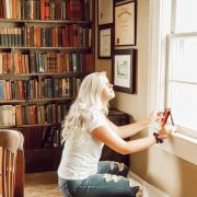 A woman measuring her window with sun comes in