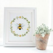 A sweet print of a honeybee and daisy chain.