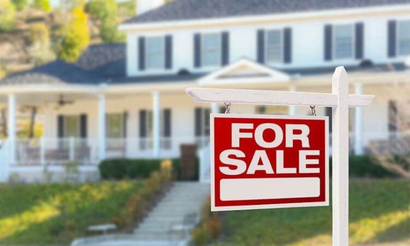 Picture of a for sale sign in front of a home