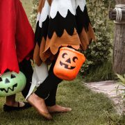 Children carrying candy-buckets in farmhouse costumes, ready for some trick-or-treating!