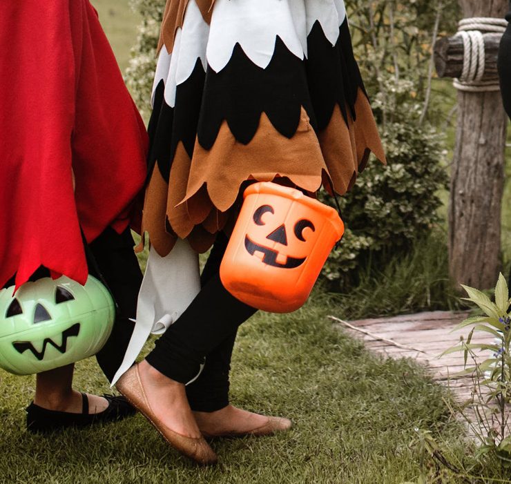 Children carrying candy-buckets in farmhouse costumes, ready for some trick-or-treating!