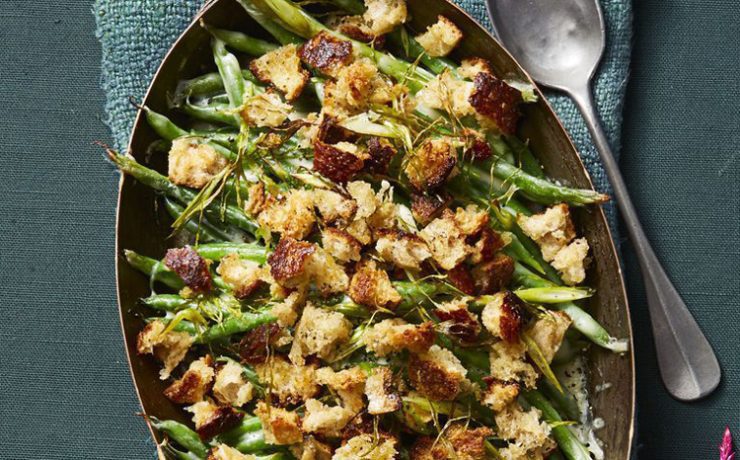 A gem among Thanksgiving recipes, this one has green beans, cheddar cheese and bread crumbs in an oval skillet.