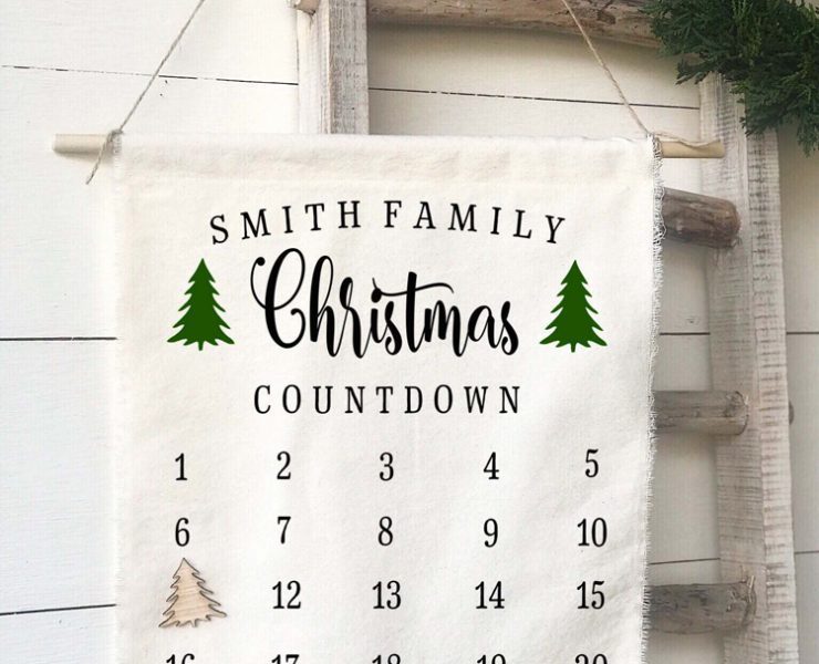 A cream-colored fabric advent calendar that can be personalized with a family name at the top.