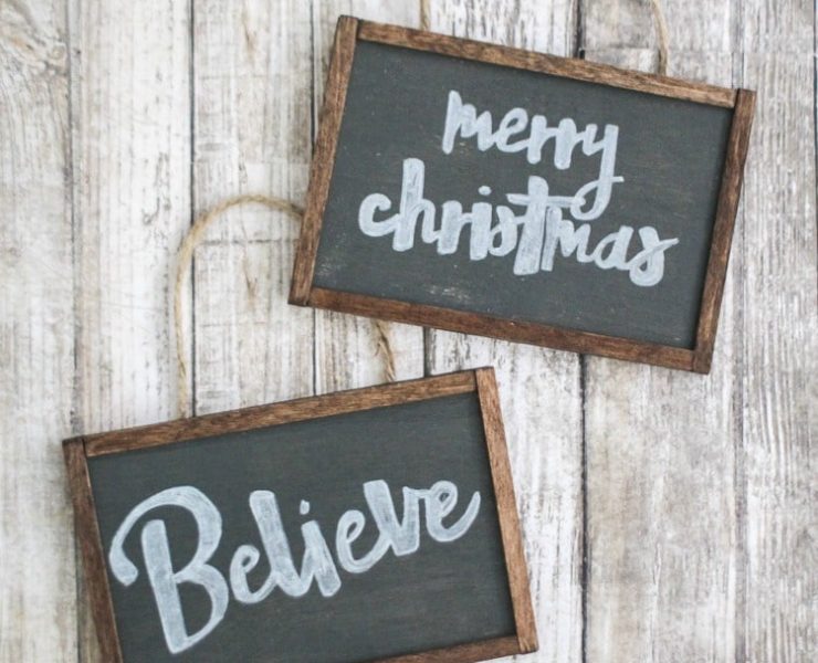 Mini, rectangular blackboard ornaments with rustic wood frames and white calligraphy in the centers.