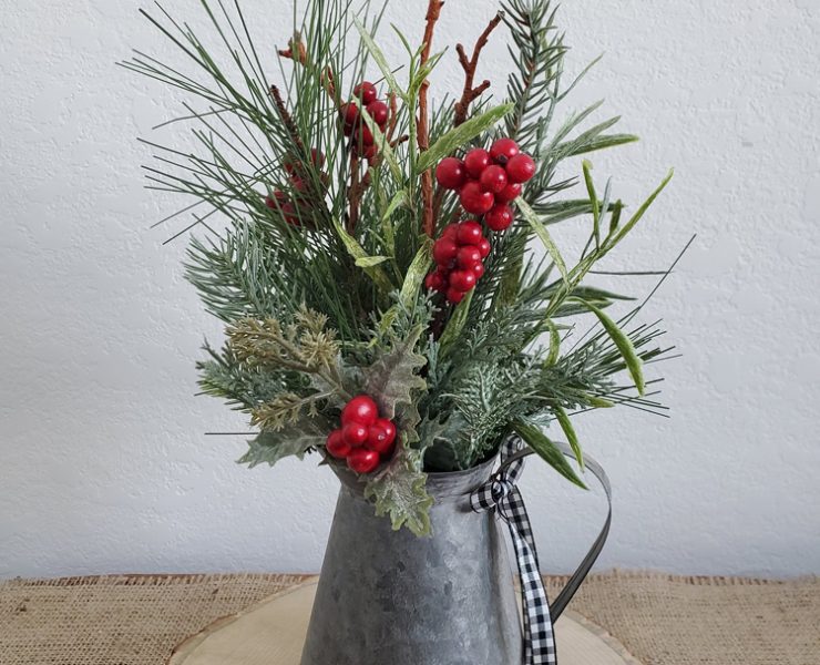 This farm-fresh Christmas decor item is a galvanized steel pitcher full of faux spruce tips and cranberry bushels.
