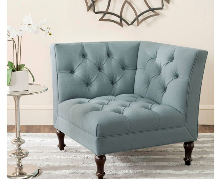 This piece of farmhouse furniture is a light blue, tufted accent chair.