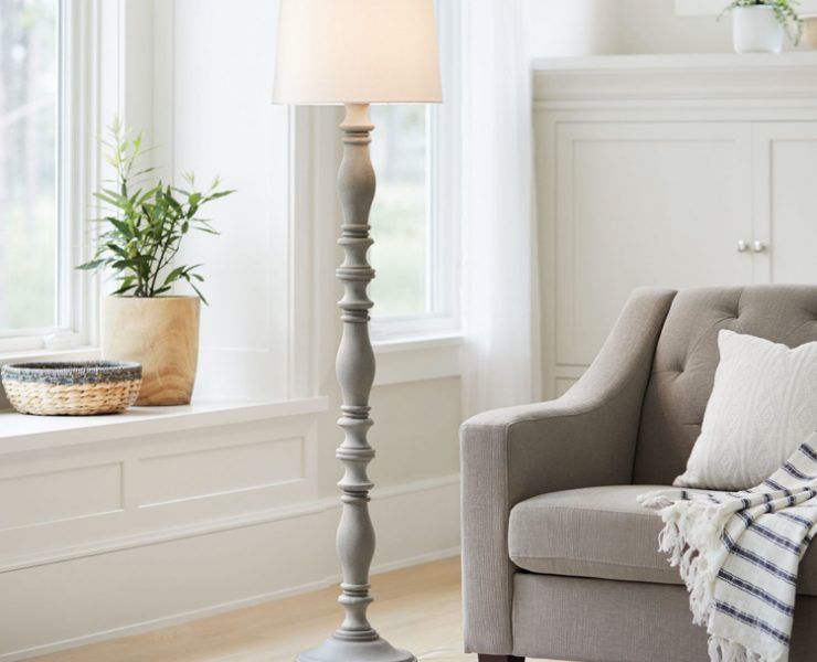 A light gray, wooden farmhouse style floor lamp.