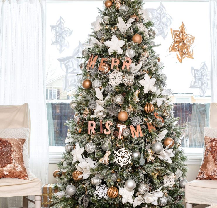 Silver and gold metallic Christmas tree with giant paper snowflakes