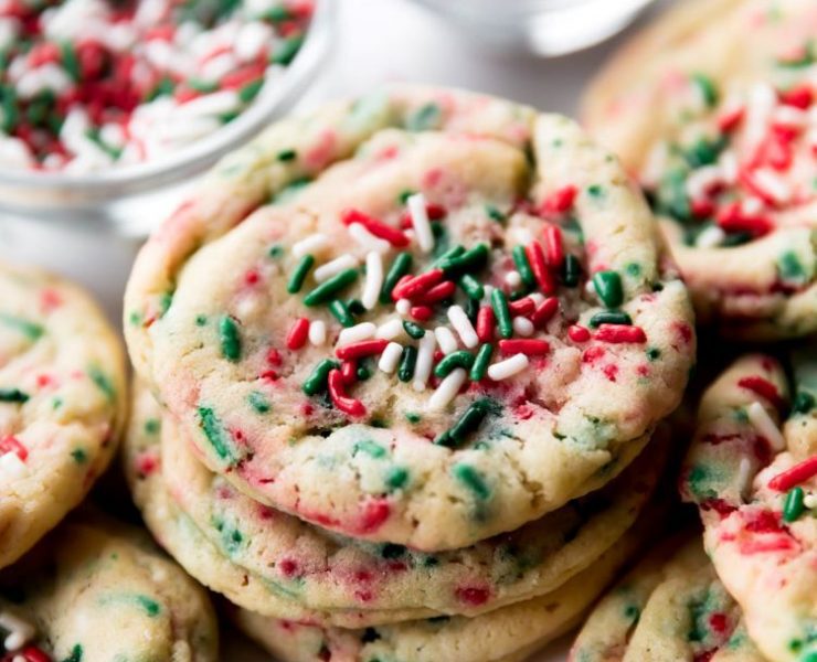 A stack of drop style sugar cookies with red, white and green sprinkles