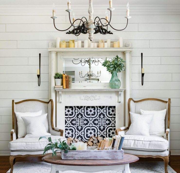 A classic white mantelpiece. Instead of a fire, the mantel sports a blue and white tiling with a unique pattern