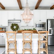 White farmhouse kitchen with sugar mold centerpiece on island