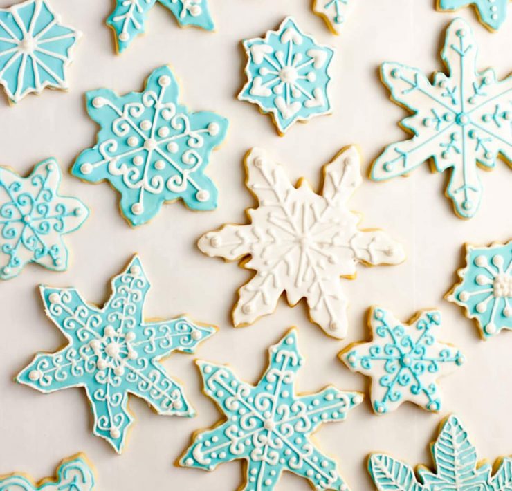 Iced sugar cookies in delicate baby blue and white frosting swirls