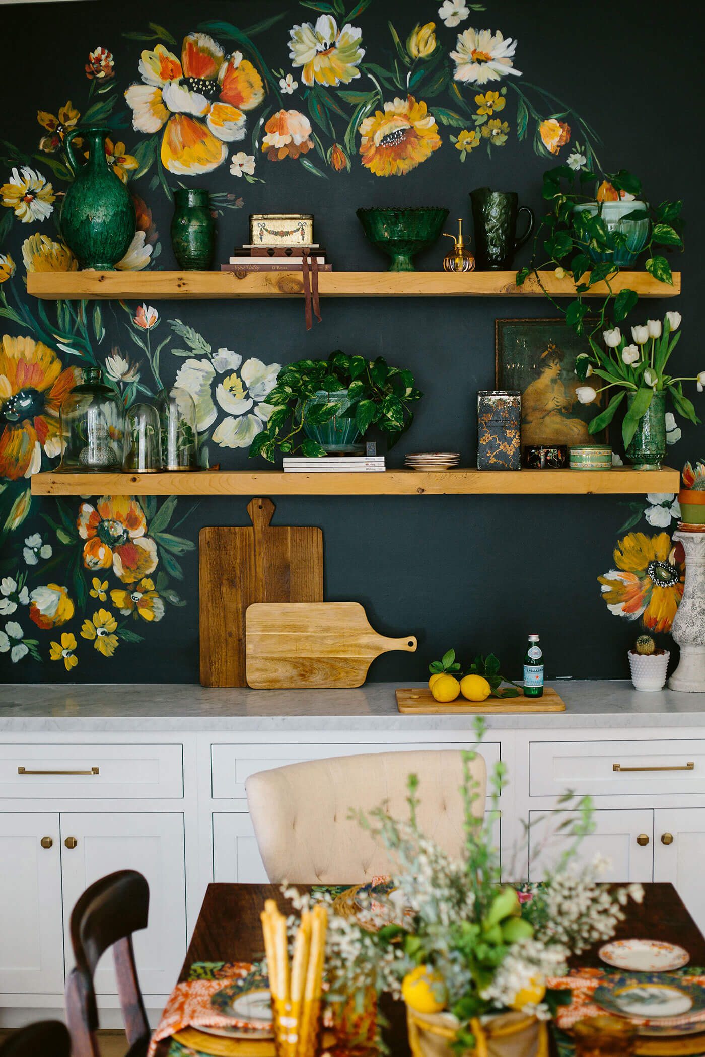 Kitchen with floral pattern on walls above open shelves