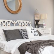 Gray bedroom with white bed