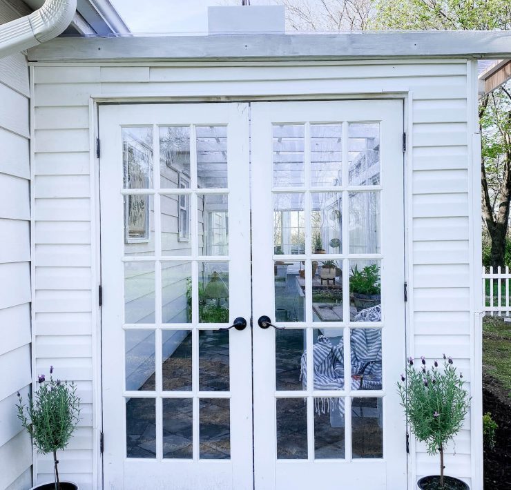 French doors leading into greenhouse garden