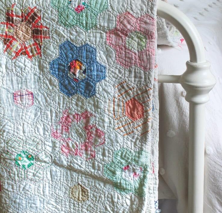 Vintage quilt on back of bed