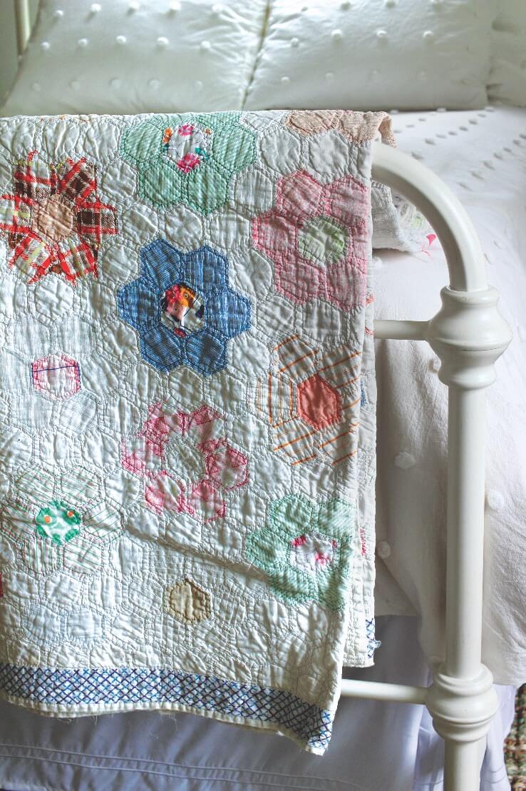 Vintage quilt on back of bed