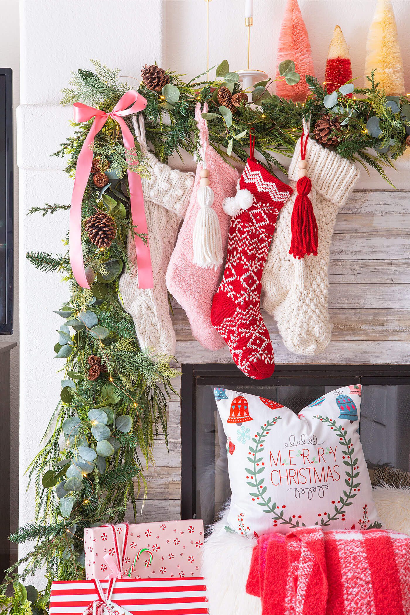 pink and red christmas color palette with stockings on mantel