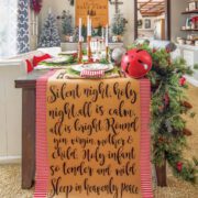 Dining table with Christmas garland, sign art and set table