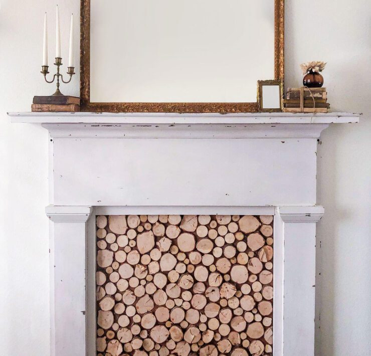 Faux fireplace with wood slice insert and mirror