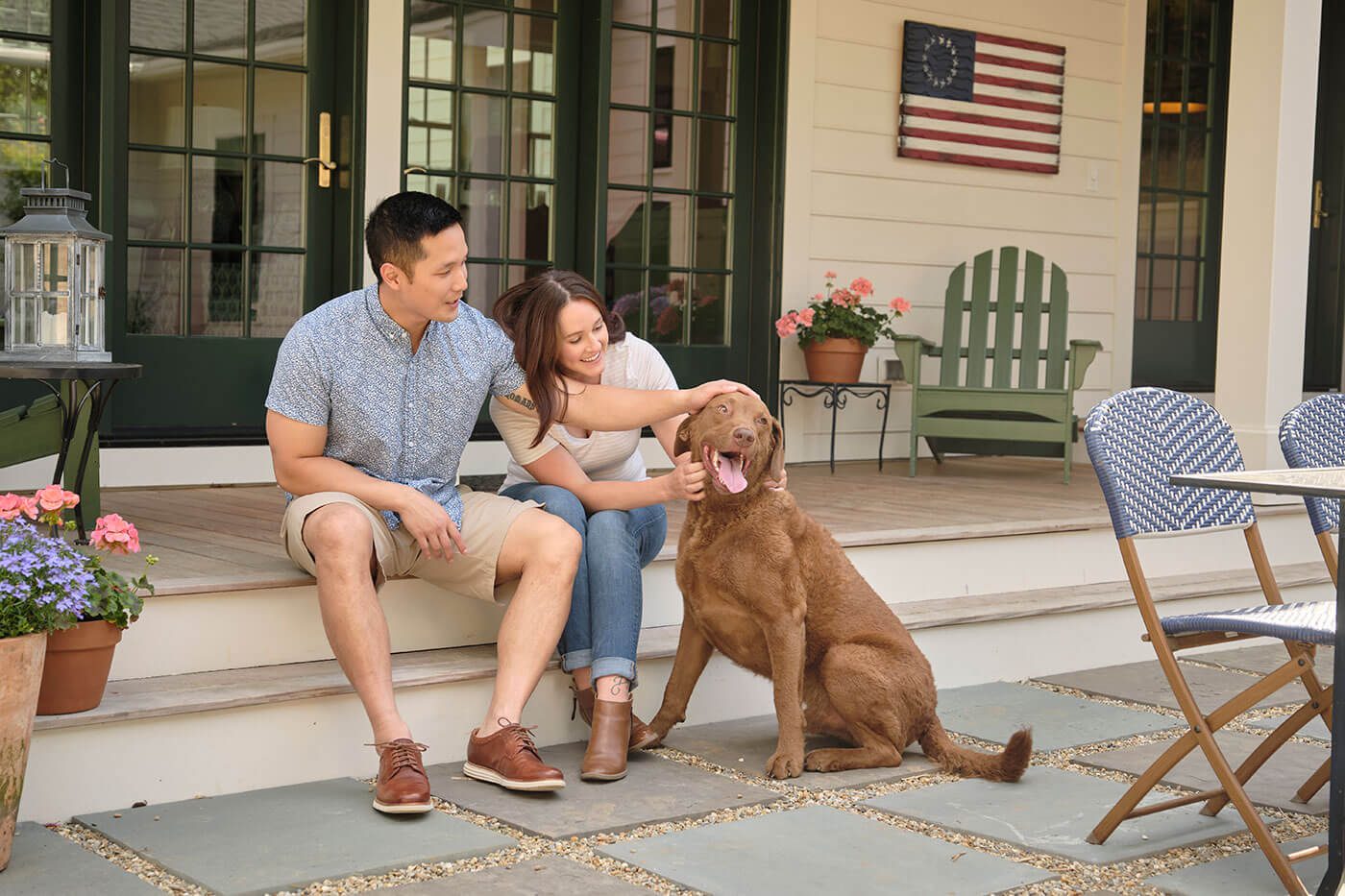 Couple sitting on patio with dog