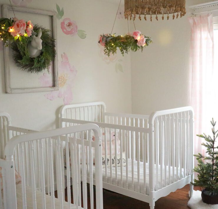 twins nursery with christmas greenery