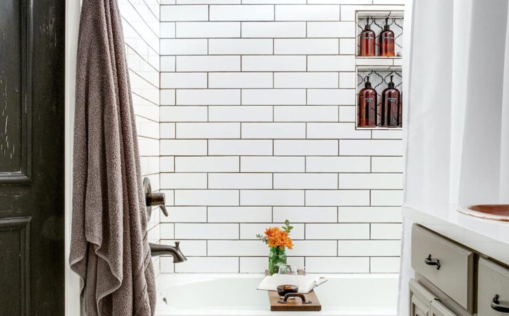 black and white floral mosaic tile in bathroom with white subway tile