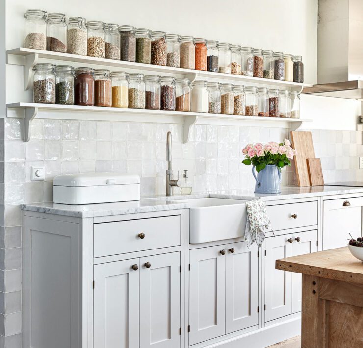 exposed shelves with spices and dry goods in jars