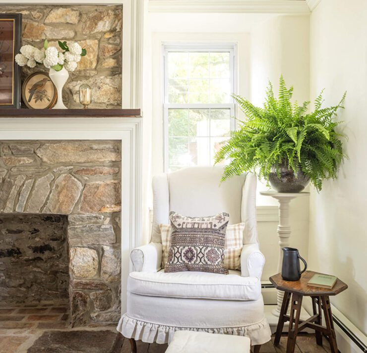 historic home with stone fireplace and exposed wood ceiling beams
