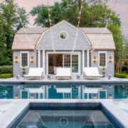 Pool with pool house in farmhouse style