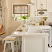 Kitchen with white countertops, cream walls and farmhouse style