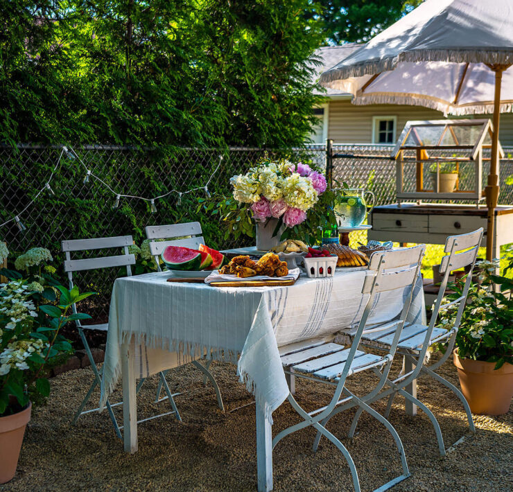 outdoor dining table set with flowers and summer watermelon and fried chicken
