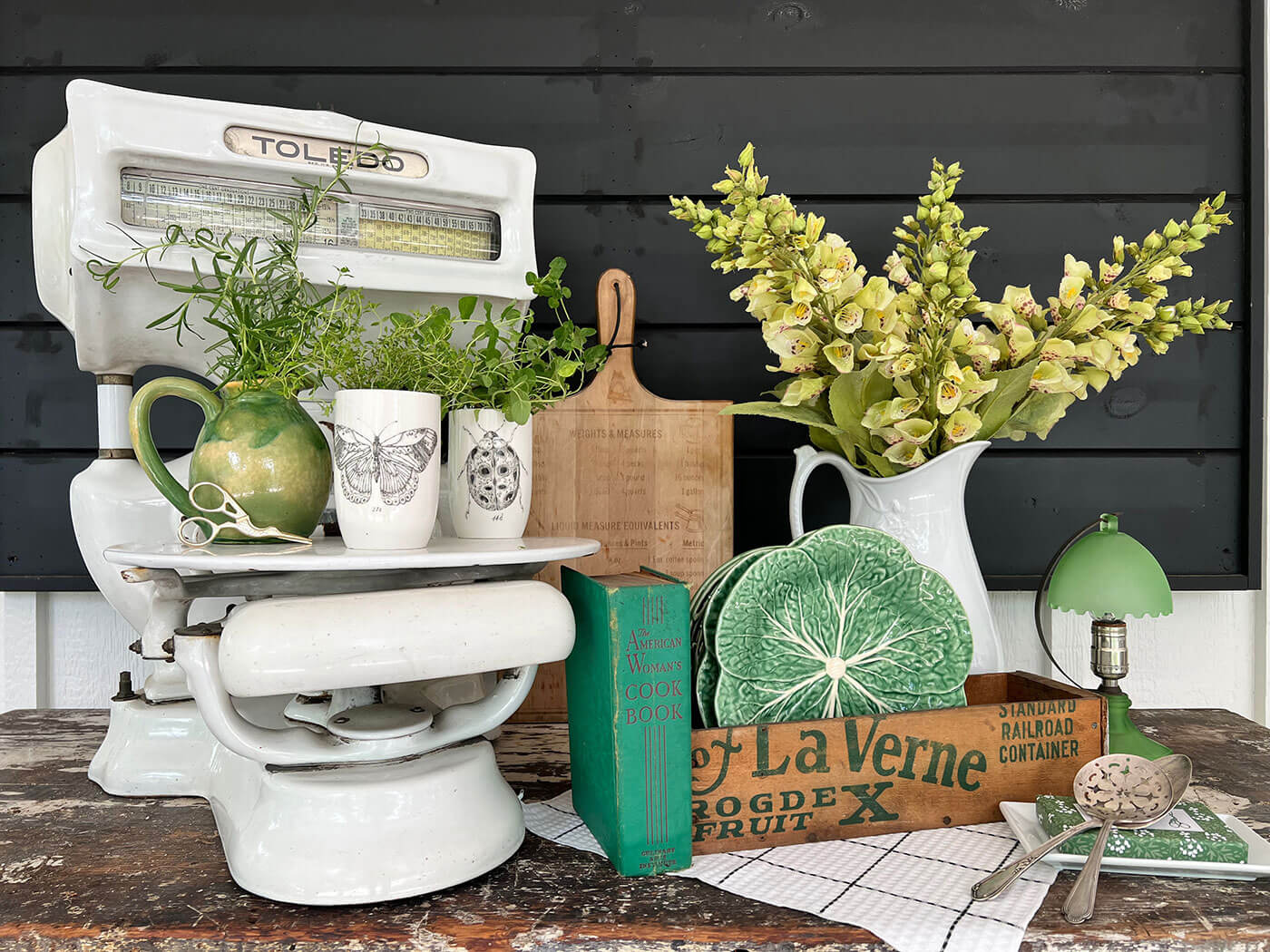 Decorating vignette with green vintage items with herb garden